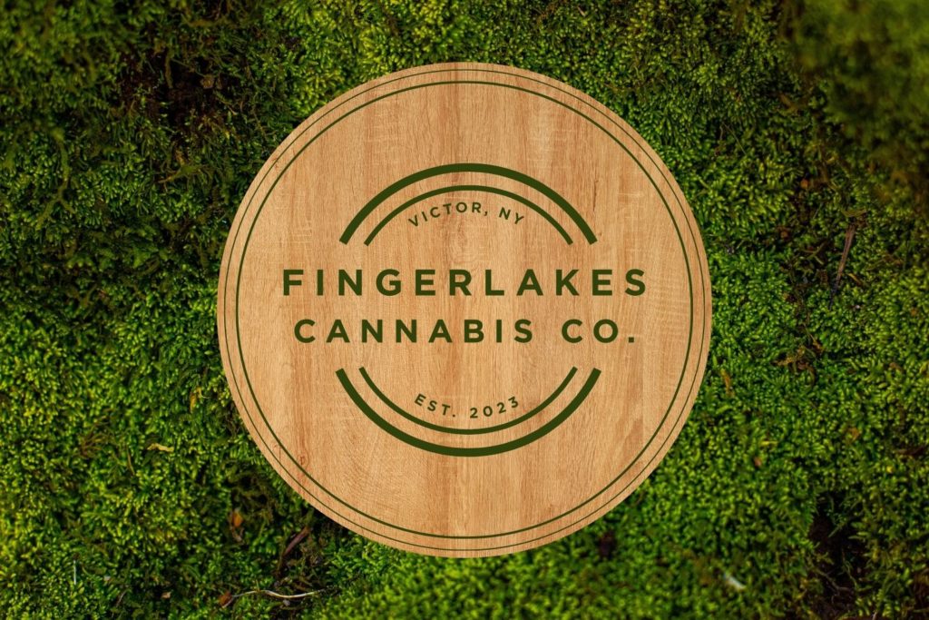 FingerLakes Cannabis Co. Homepage Dark Green Background Image with Wooden Logo and Moss